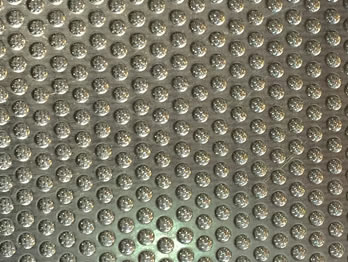 Sintered mesh filter supported with perforated mesh layer with round hols